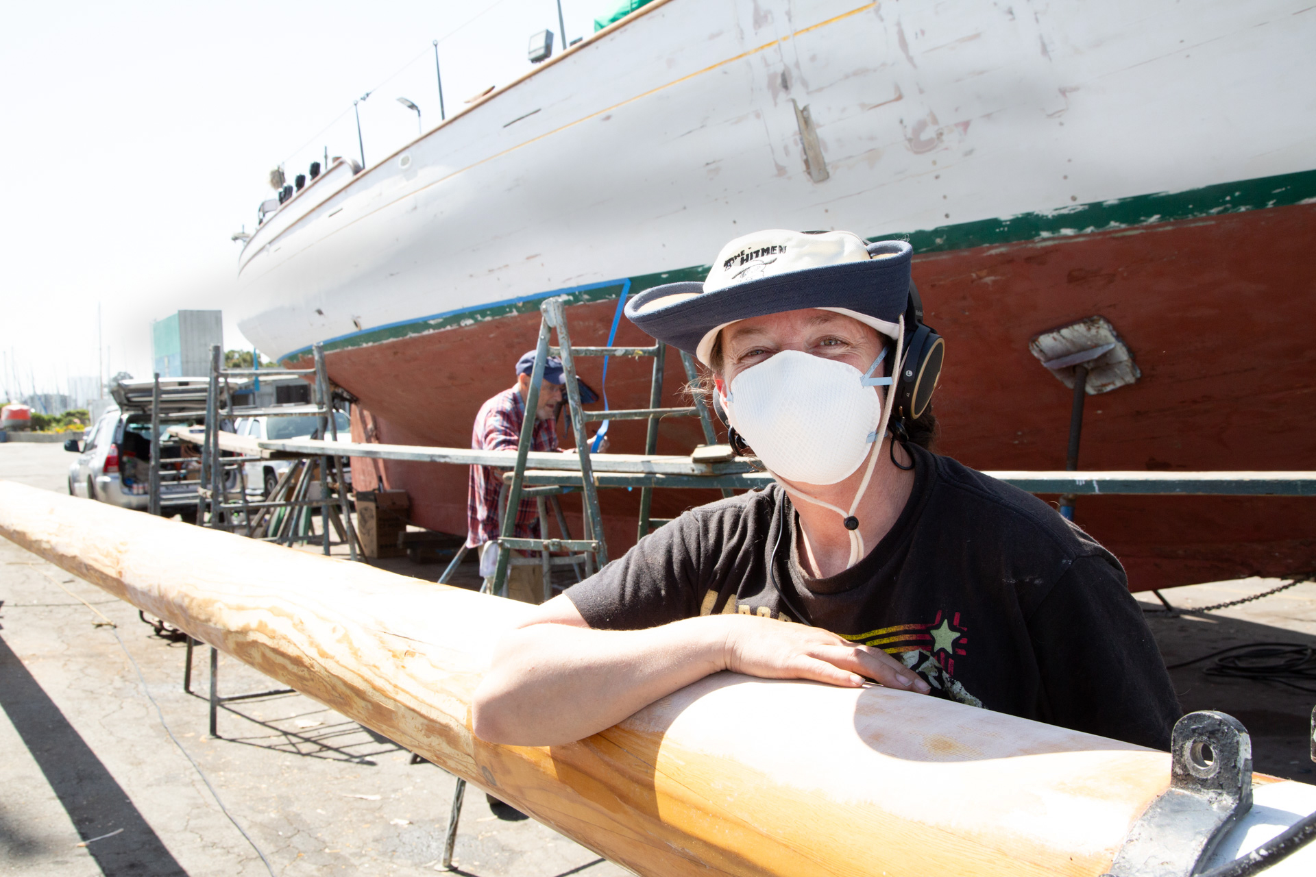 Lindsey Klaus sanding Brigadoon's mast