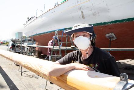 Lindsey Klaus sanding Brigadoon's mast